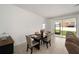 Modern dining area featuring tile flooring, a slider to the lanai, and contemporary furnishings at 7224 Sw 61St Pl, Ocala, FL 34474