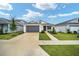 Inviting single-story home with a manicured front lawn, a concrete driveway, and charming front garden landscaping at 7224 Sw 61St Pl, Ocala, FL 34474