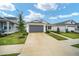 Beautiful single-story home featuring a well-kept lawn, a concrete driveway, and welcoming front yard landscaping at 7224 Sw 61St Pl, Ocala, FL 34474