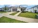 Attractive one-story home with manicured lawn, front garden, concrete driveway, and charming, covered front entrance at 7224 Sw 61St Pl, Ocala, FL 34474