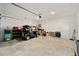 Spacious garage featuring a golf cart, storage and access door at 7224 Sw 61St Pl, Ocala, FL 34474