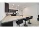 A modern kitchen features an island with seating and granite countertops at 7224 Sw 61St Pl, Ocala, FL 34474