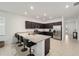 Spacious kitchen island with granite countertops, seating, and dark wood cabinets at 7224 Sw 61St Pl, Ocala, FL 34474