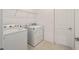 Functional laundry room with modern washer and dryer and convenient shelving at 7224 Sw 61St Pl, Ocala, FL 34474
