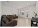 Inviting living room with tile floors, neutral walls, and comfortable couches perfect for relaxation at 7224 Sw 61St Pl, Ocala, FL 34474