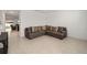 Comfortable living room area featuring tile flooring, a plush sectional sofa, and a spacious layout for relaxing at 7224 Sw 61St Pl, Ocala, FL 34474