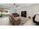 Comfortable living room with ceiling fan, large TV, and access to the backyard at 7224 Sw 61St Pl, Ocala, FL 34474