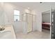 Bright bathroom featuring double sinks, tile flooring, and walk-in shower at 7224 Sw 61St Pl, Ocala, FL 34474