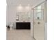 Ensuite bathroom featuring double vanity, walk-in shower, and tile flooring at 7224 Sw 61St Pl, Ocala, FL 34474