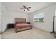 Bright main bedroom featuring neutral decor, tile flooring, and a large window at 7224 Sw 61St Pl, Ocala, FL 34474