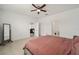 Open main bedroom showcasing a bed, dresser, and view into the ensuite bathroom at 7224 Sw 61St Pl, Ocala, FL 34474