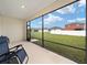 A view of the backyard and fence seen from screened-in patio, complete with seating at 7224 Sw 61St Pl, Ocala, FL 34474