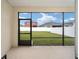 Screened in patio, showing lawn and fence of neighboring home at 7224 Sw 61St Pl, Ocala, FL 34474
