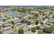Community aerial showing manicured lawns and landscaping, as well as neighborhood amenities including water features and green space at 7333 Sw 98Th Ct, Ocala, FL 34481
