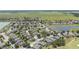 Wide aerial view showcasing a community with ponds and green space including a golf course and well-maintained landscaping at 7333 Sw 98Th Ct, Ocala, FL 34481
