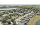 Aerial view highlighting the neighborhood's mature trees, landscaping, water features, and well-maintained homes at 7333 Sw 98Th Ct, Ocala, FL 34481