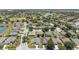 Expansive aerial view showcases a beautiful residential community with lush landscaping, serene lake, and golf course views at 7333 Sw 98Th Ct, Ocala, FL 34481