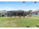 Lush backyard with a screened-in lanai, ideal for entertaining and enjoying the outdoors at 7333 Sw 98Th Ct, Ocala, FL 34481