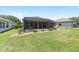 Serene backyard with screened lanai, offering a relaxing outdoor space for leisure and gatherings at 7333 Sw 98Th Ct, Ocala, FL 34481