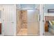 Walk-in shower featuring glass doors, brick-style tiling, and natural lighting for a modern, luxurious bathing experience at 7333 Sw 98Th Ct, Ocala, FL 34481