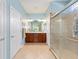 Bathroom boasts dual sinks, ample lighting, and glass-enclosed shower for a spa-like experience in a modern design at 7333 Sw 98Th Ct, Ocala, FL 34481