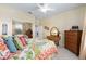 Comfortable bedroom featuring a colorful quilt, mirrored closet doors, and classic wooden furnishings at 7333 Sw 98Th Ct, Ocala, FL 34481