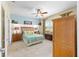 Cozy bedroom with a ceiling fan, soft carpet, and ample natural light, perfect for relaxation at 7333 Sw 98Th Ct, Ocala, FL 34481
