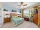Comfortable bedroom featuring plush carpeting, a ceiling fan, and a bright window view for a relaxing retreat at 7333 Sw 98Th Ct, Ocala, FL 34481