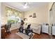 Versatile room with wood floors, a comfortable sofa, and workout equipment, perfect as a bonus area at 7333 Sw 98Th Ct, Ocala, FL 34481