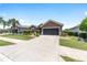 Charming single-story home featuring a neatly landscaped front yard and a two-car garage at 7333 Sw 98Th Ct, Ocala, FL 34481
