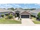 Inviting single-story home featuring a neatly landscaped front yard and a two-car garage at 7333 Sw 98Th Ct, Ocala, FL 34481