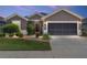Charming home exterior with a manicured lawn and a two-car garage, great curb appeal and design at 7333 Sw 98Th Ct, Ocala, FL 34481