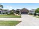 Charming single-story home featuring a neatly landscaped front yard and a two-car garage at 7333 Sw 98Th Ct, Ocala, FL 34481
