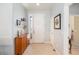 Bright foyer featuring tile flooring, a wooden cabinet, and a view of the home's interior at 7333 Sw 98Th Ct, Ocala, FL 34481