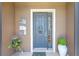 Charming front door with a decorative wreath, surrounded by potted plants and stylish exterior decor at 7333 Sw 98Th Ct, Ocala, FL 34481