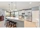 Kitchen with stainless steel appliances, breakfast bar, and ample cabinet space, seamlessly connects to outdoor living at 7333 Sw 98Th Ct, Ocala, FL 34481
