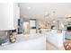 Bright kitchen featuring stainless appliances, white cabinets, and spacious marble countertops for meal preparation and entertaining at 7333 Sw 98Th Ct, Ocala, FL 34481