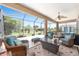 Spacious screened-in lanai featuring comfortable wicker furniture and views of the well-maintained backyard at 7333 Sw 98Th Ct, Ocala, FL 34481