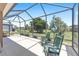 Relaxing screened-in lanai featuring rocking chairs, offering a comfortable space to enjoy the outdoor scenery at 7333 Sw 98Th Ct, Ocala, FL 34481