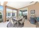 Outdoor patio offers a dining area, lounge seating, and views of the lush backyard through the screened-in enclosure at 7333 Sw 98Th Ct, Ocala, FL 34481