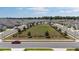 Aerial view of green community common area with lush lawn, trees, and homes in the neighborhood at 7571 Sw 64Th Street Rd, Ocala, FL 34474