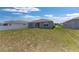 Wide backyard featuring healthy grass, a white fence, and a view of the rear facade at 7571 Sw 64Th Street Rd, Ocala, FL 34474