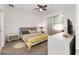 Cozy bedroom with neutral carpeting, a ceiling fan, and a comfortable queen-sized bed at 7571 Sw 64Th Street Rd, Ocala, FL 34474