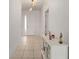 Bright foyer features tile flooring, a modern light fixture, and a white accent table at 7571 Sw 64Th Street Rd, Ocala, FL 34474