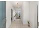 Bright foyer features tile flooring, a modern light fixture, and a view into the living area at 7571 Sw 64Th Street Rd, Ocala, FL 34474