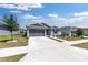 Attractive single-story home with gray siding, a two-car garage, and a manicured lawn at 7571 Sw 64Th Street Rd, Ocala, FL 34474