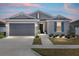 Charming single-story home with a gray exterior, blue shutters, and a well-manicured front yard at 7571 Sw 64Th Street Rd, Ocala, FL 34474