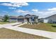 Inviting single-story house featuring gray siding, a two-car garage, and a landscaped front yard at 7571 Sw 64Th Street Rd, Ocala, FL 34474