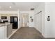 View of hall connecting the kitchen, laundry, closet, and front entrance with stylish lighting fixtures at 7571 Sw 64Th Street Rd, Ocala, FL 34474