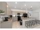 Charming kitchen featuring gray cabinets, stainless steel appliances, and a central island with seating at 7571 Sw 64Th Street Rd, Ocala, FL 34474